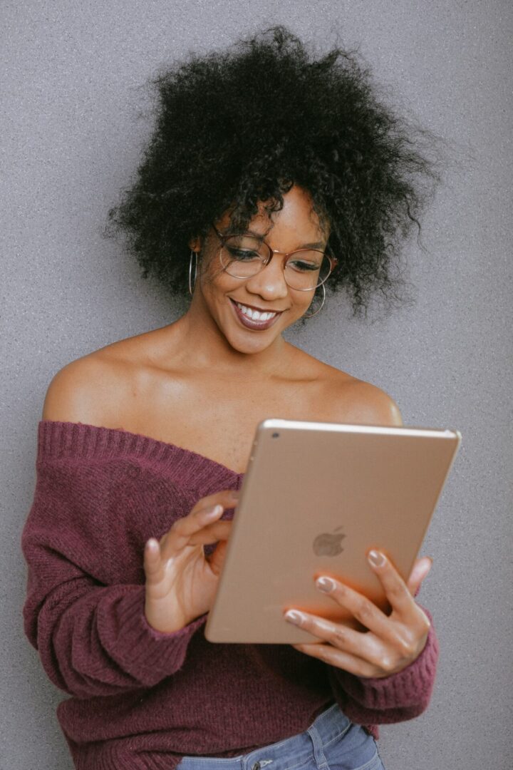 A woman holding an ipad in her hands.